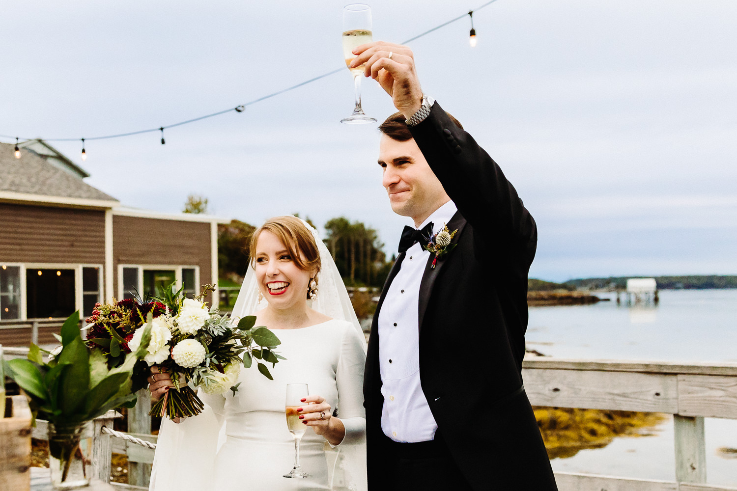 Bride and groom toast wedding guests at Contented Sole Maine wedding