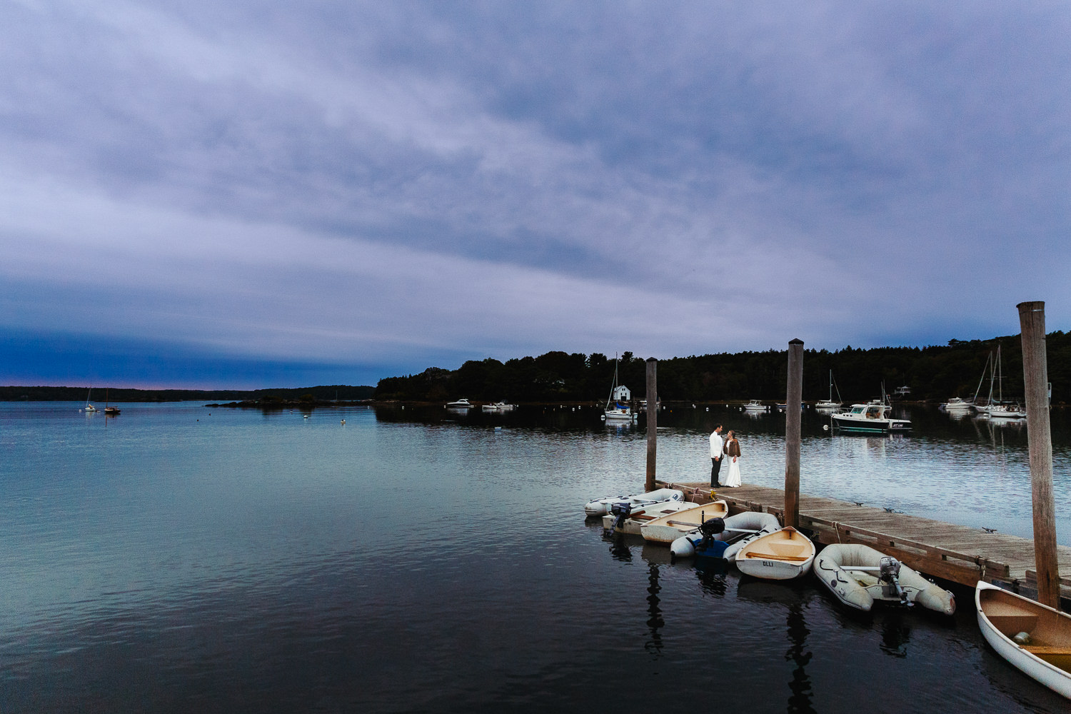 Bride and groom on dock at sunset during Contented Sole Maine wedding
