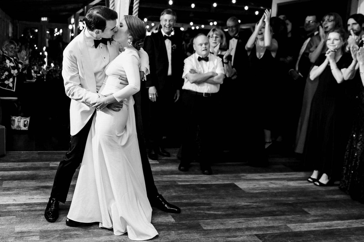 groom kissing bride after first dance