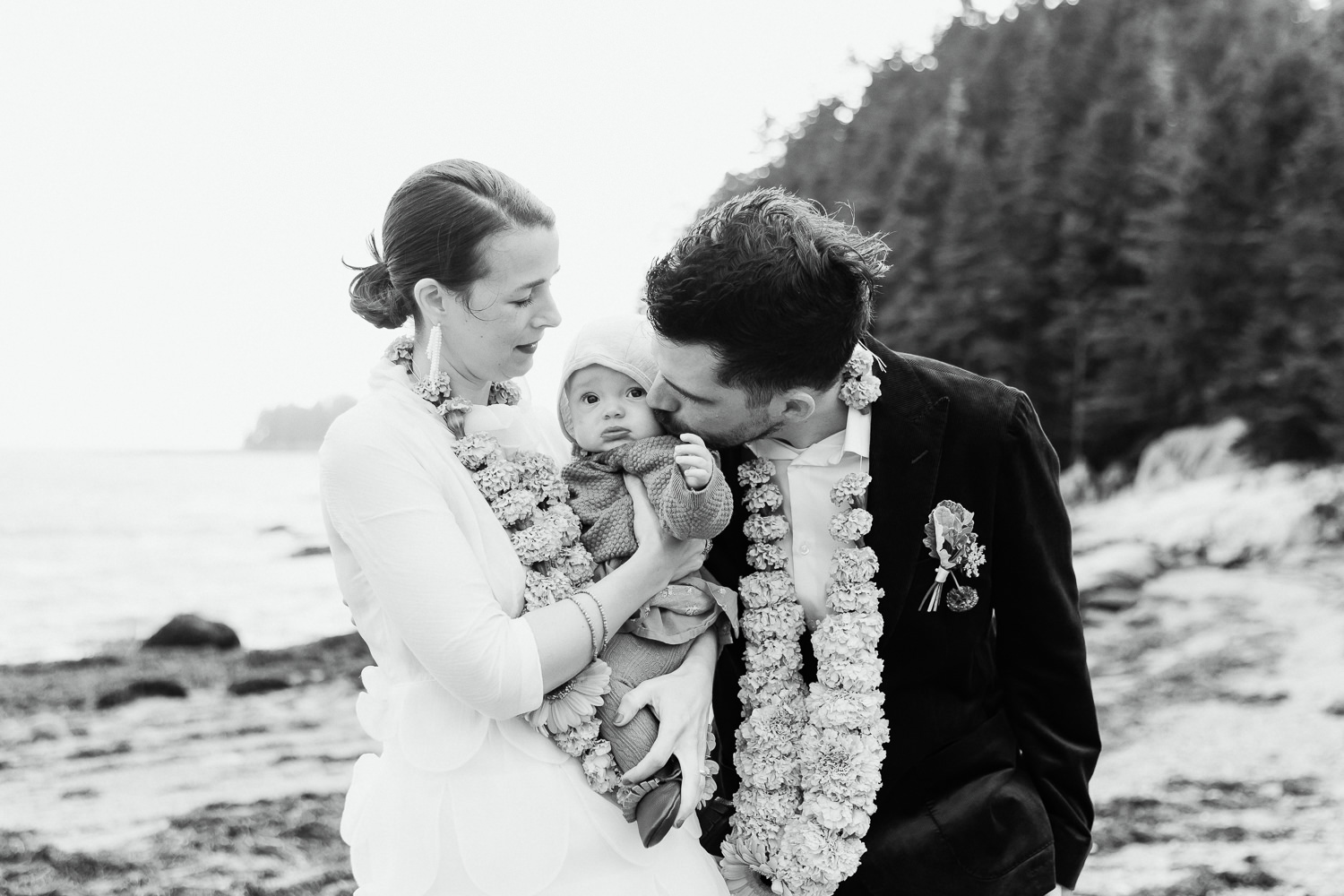 couple with their baby at Deer Isle Maine wedding