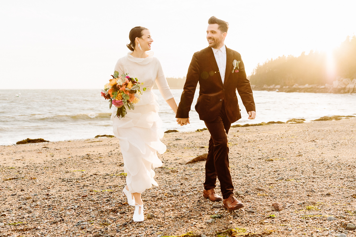 couple walking at sunset during Deer Isle Maine wedding