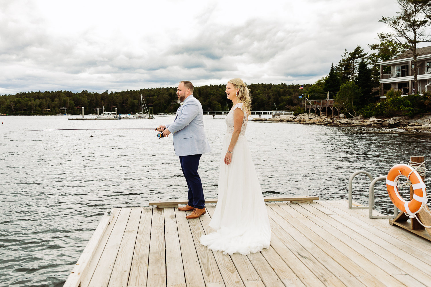 Bride and groom fishing at Boothbay Harbor Maine wedding at Linekin Bay Resort