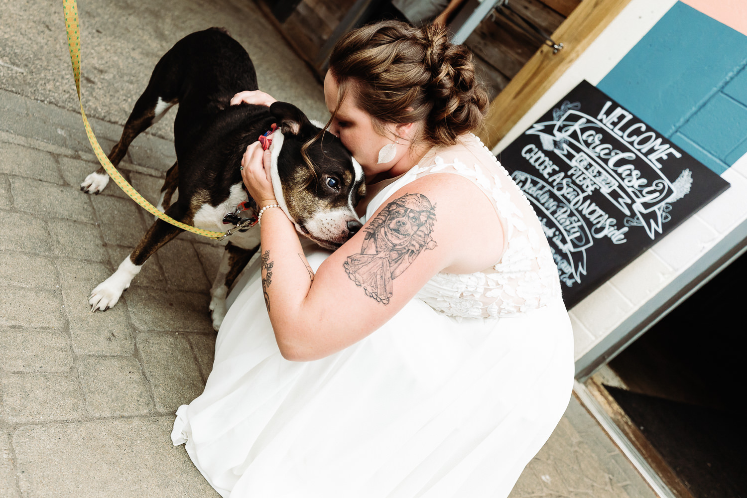 bride kissing dog at Portland Maine brewery wedding