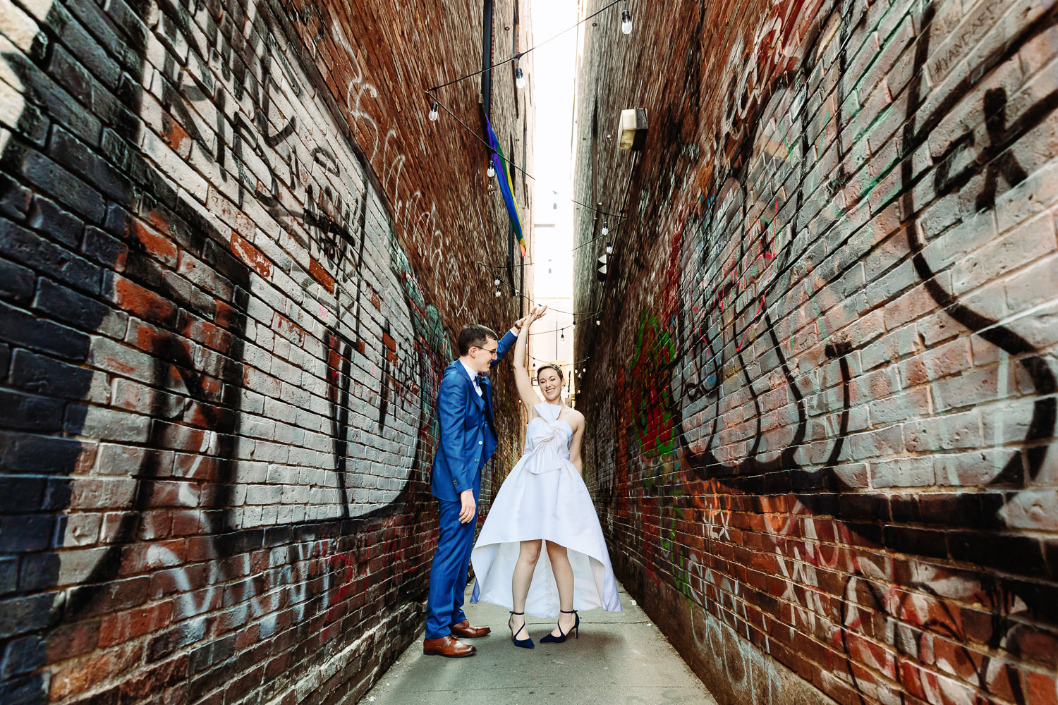 couple dancing in alley before Portland wedding at Oxbow Brewing