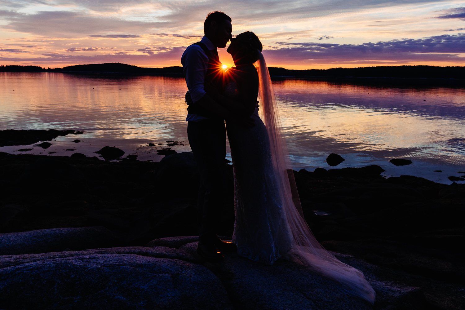 silhouette of newlyweds at sunset during Swan's Island Maine wedding