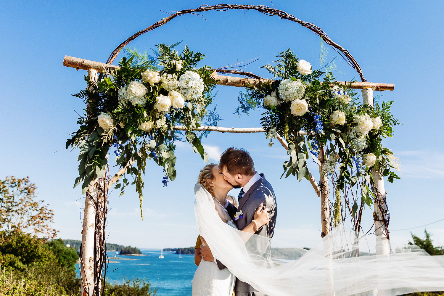 first kiss at Swan's Island Maine wedding