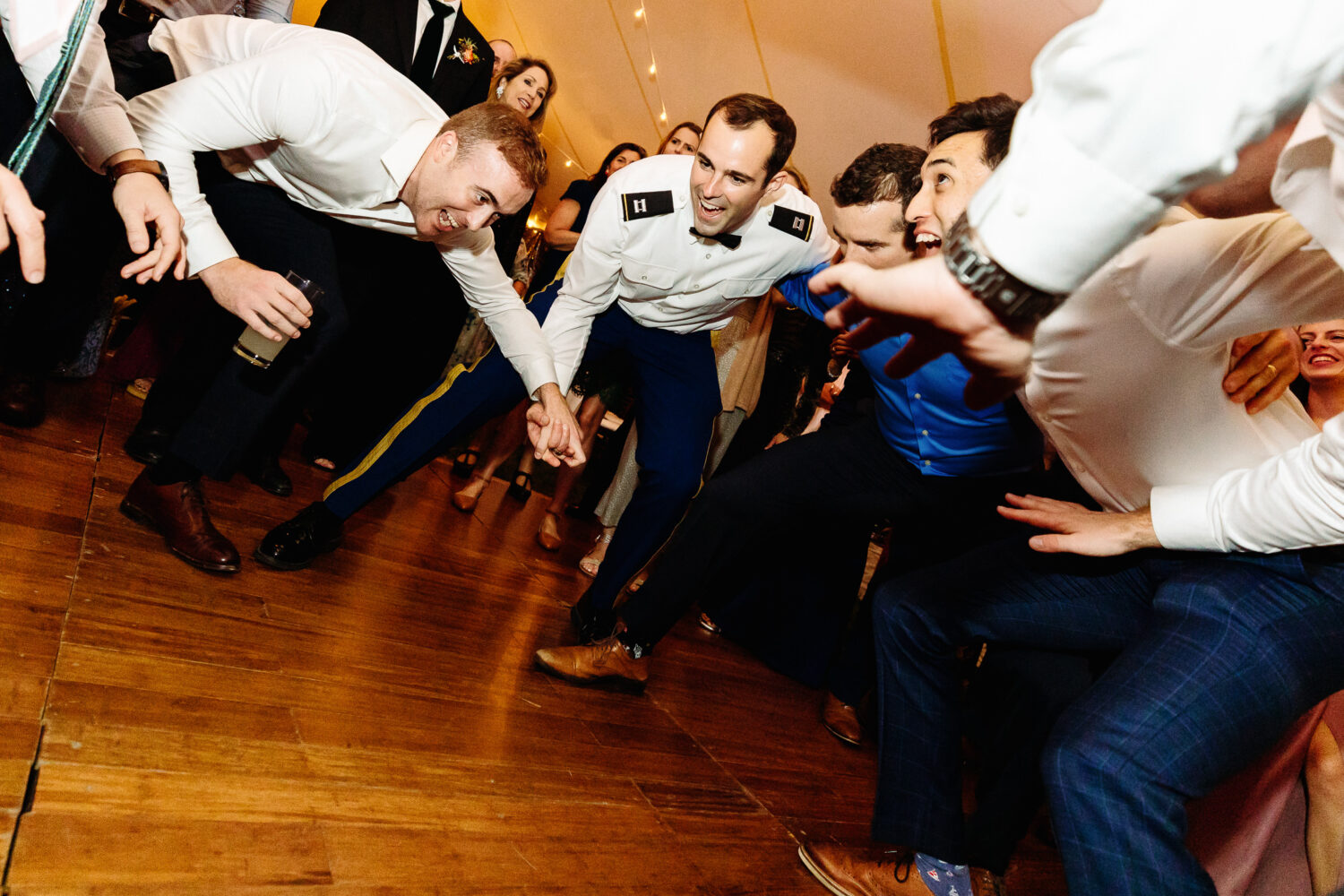groom dancing with wedding guests