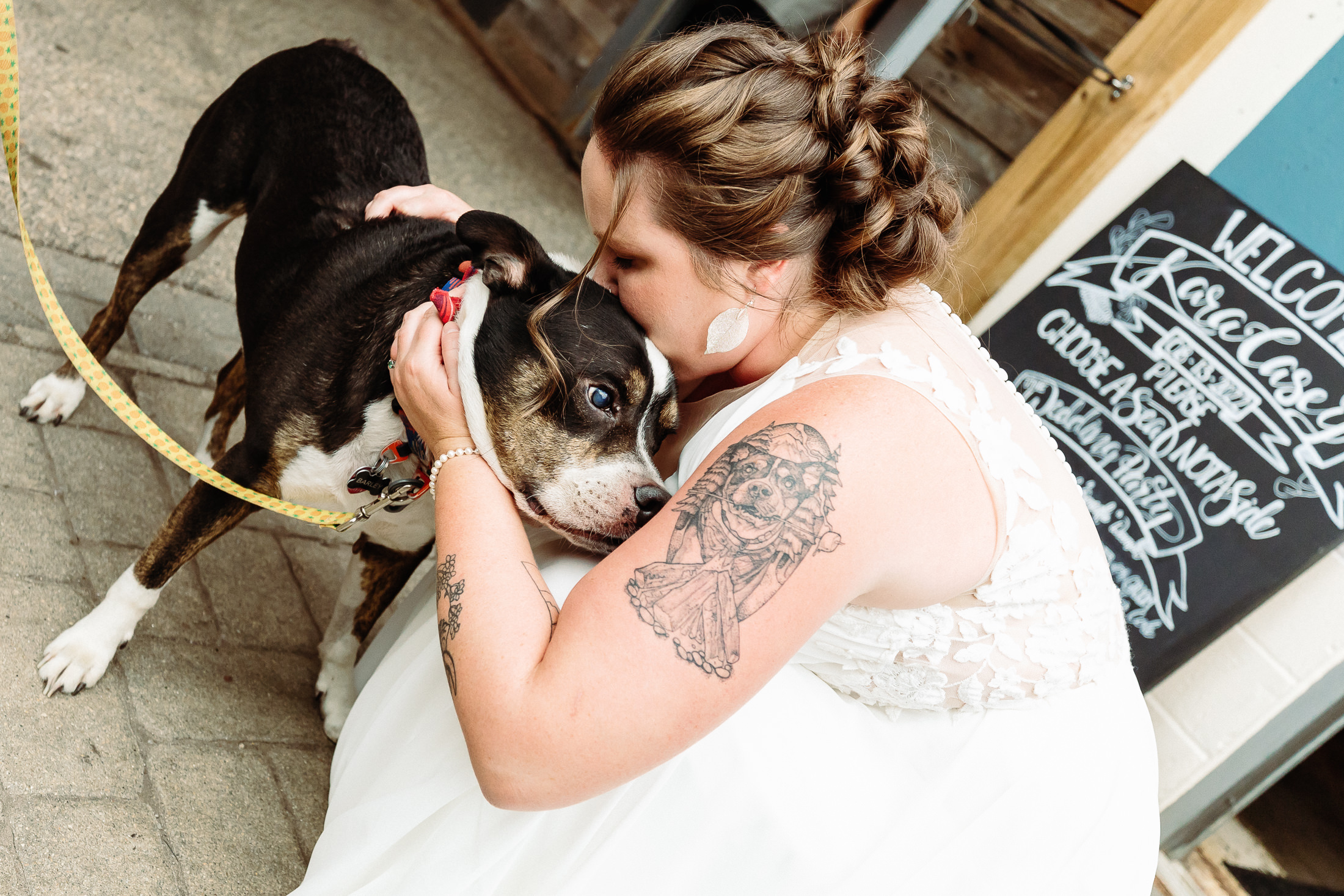 Bride kissing her dog during Portland Maine wedding