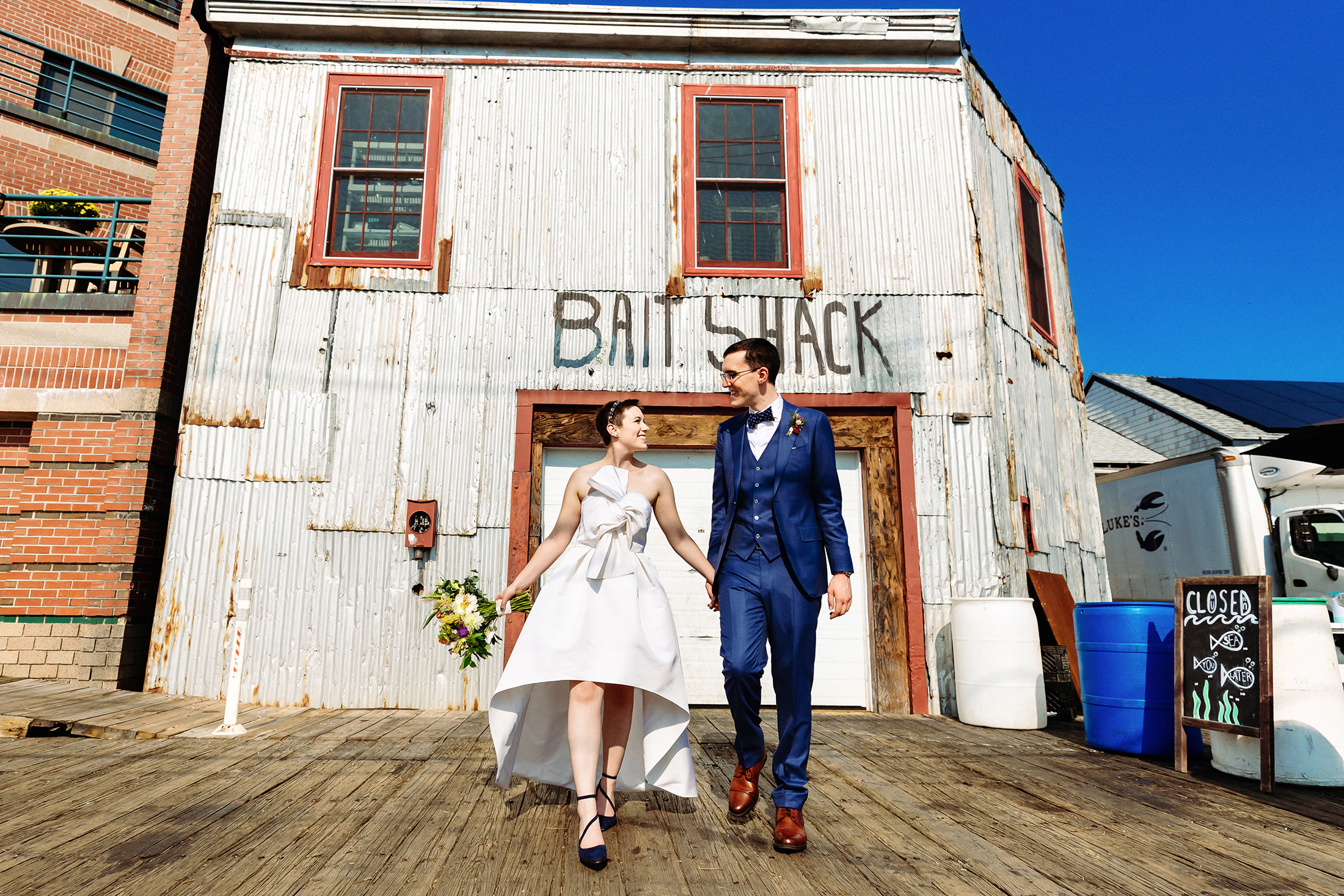 bride and groom walking in front of the Bait Shack in Portland Maine