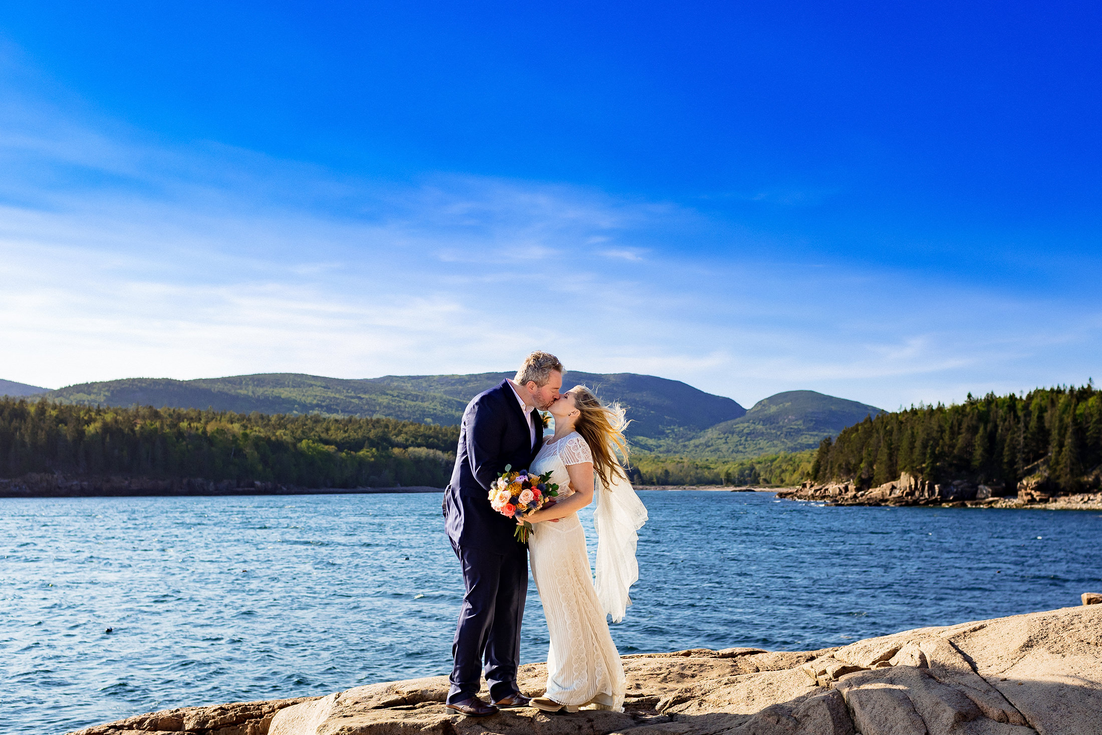 Bride and groom kiss after Otter Point Acadia elopement
