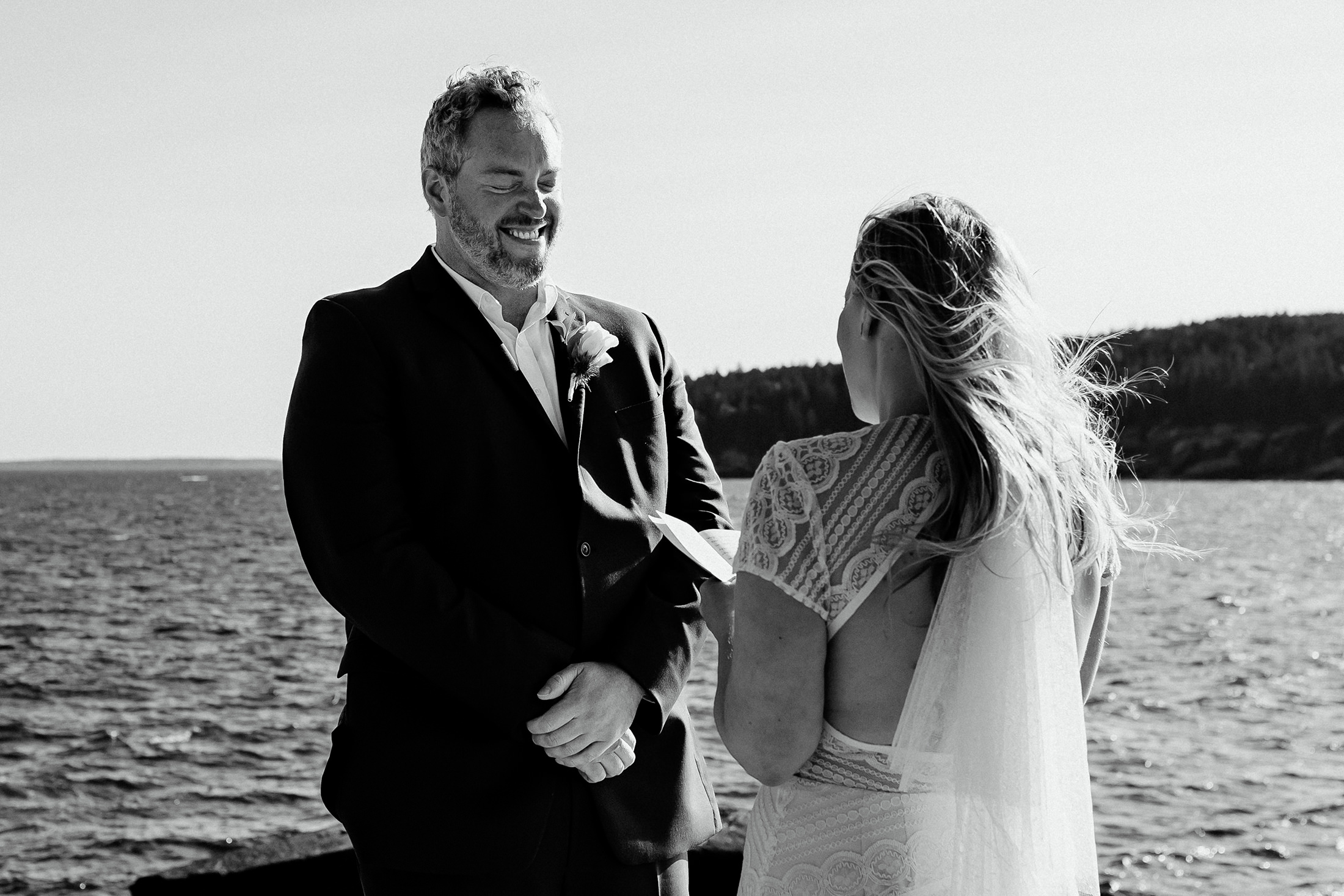 groom laughing during bride's vows at Otter Point Acadia elopement