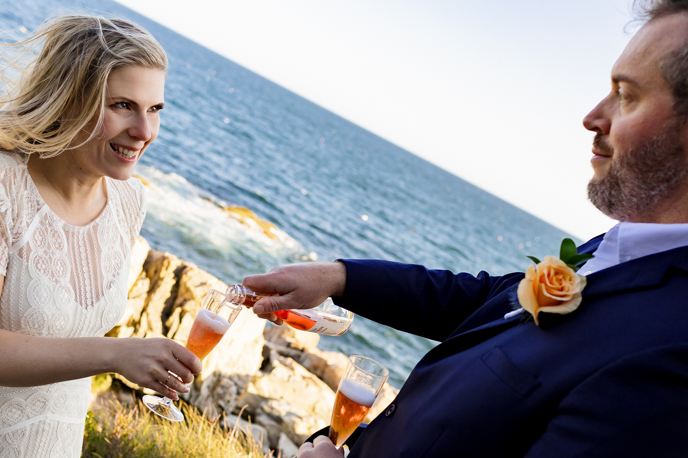 couple having pink champagne after Otter Point Acadia elopement