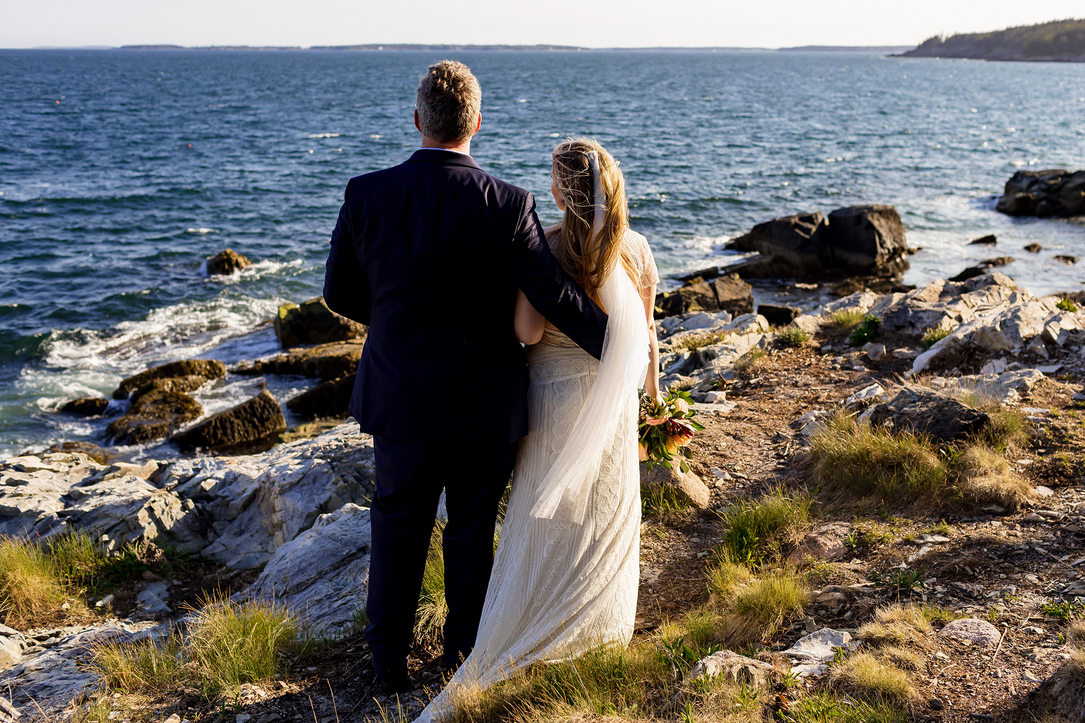 couple looking out at the ocean after Otter Point Acadia elopement