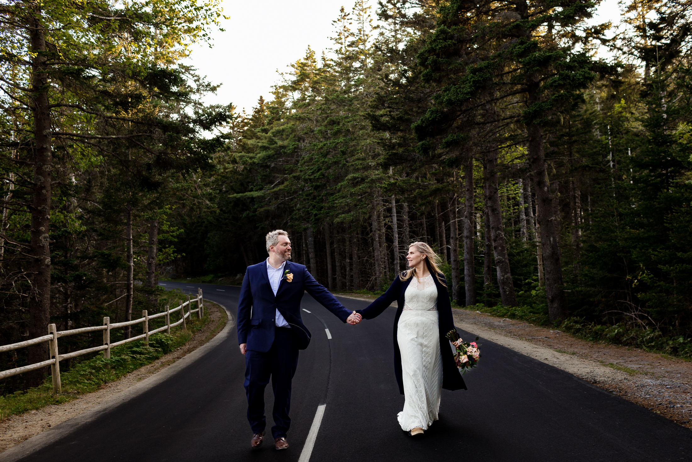 couple walking down Park Loop Road after Otter Point Acadia elopement