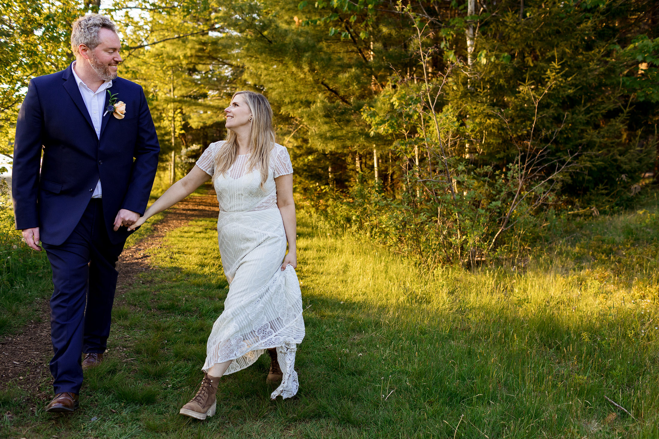 bride and groom strolling together in Acadia National Park