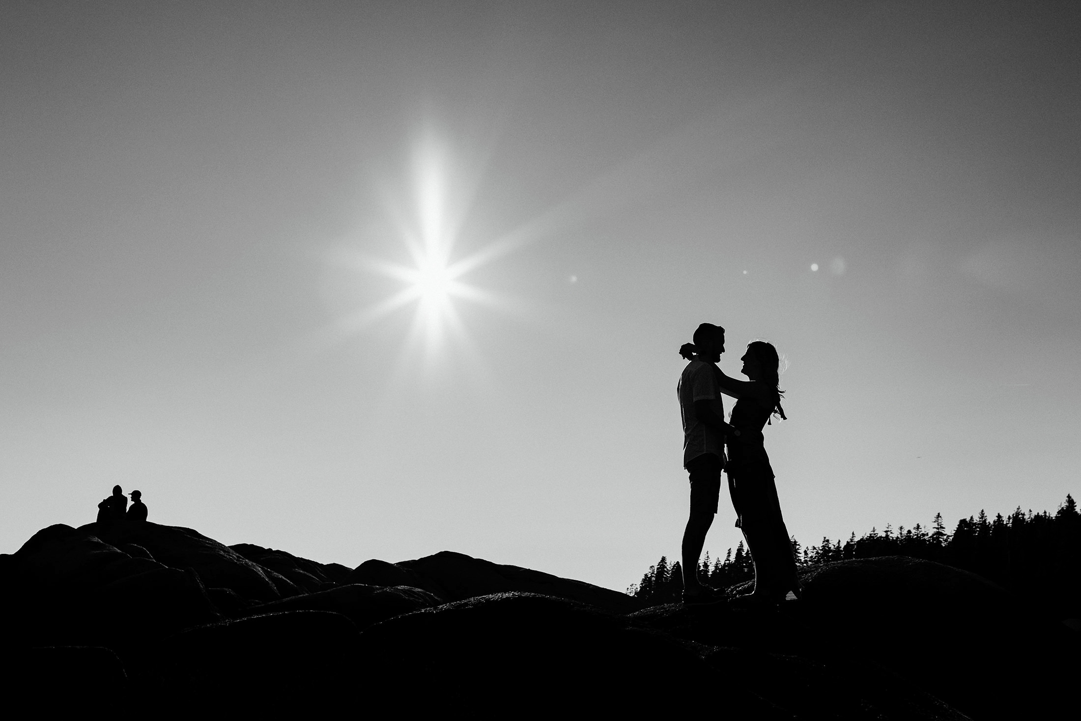 silhouette of couple on beach during Stonington Maine engagement photos