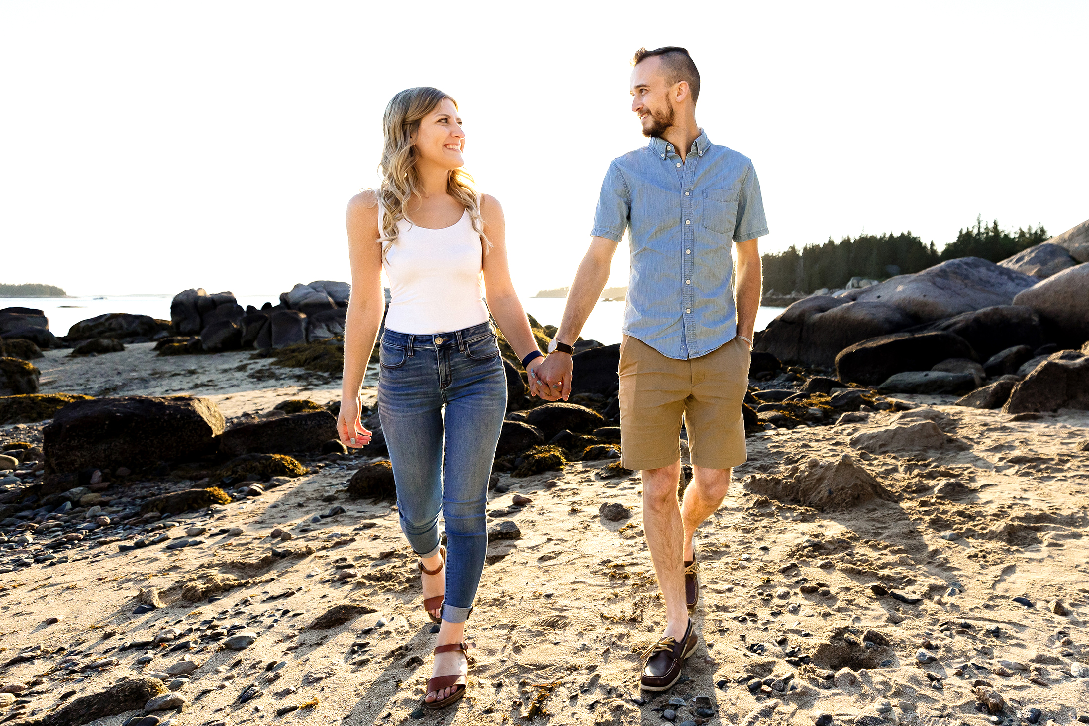 couple walking on Sand Beach during Stonington Maine engagement photos
