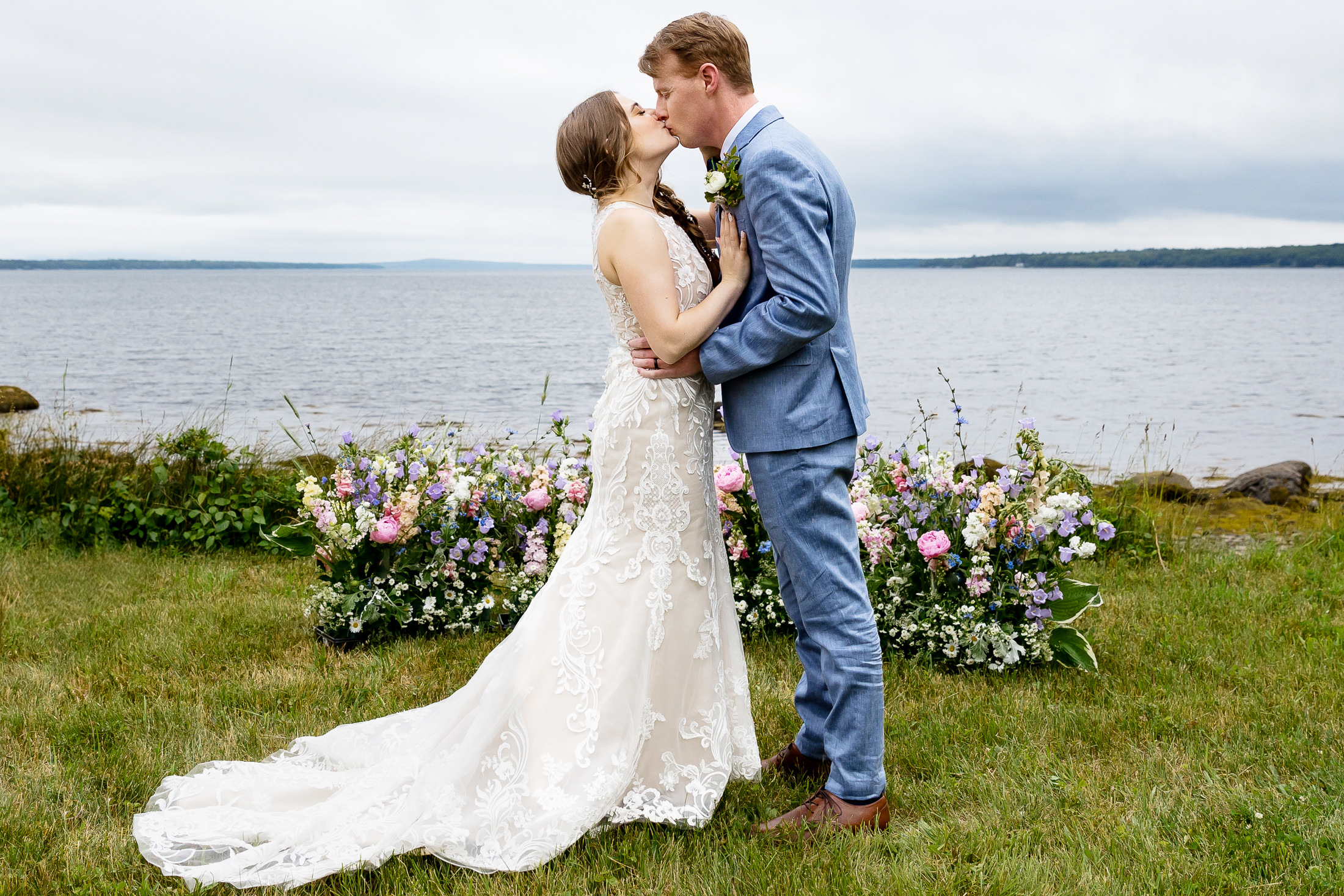 first kiss during Under Canvas Acadia wedding in Surry Maine