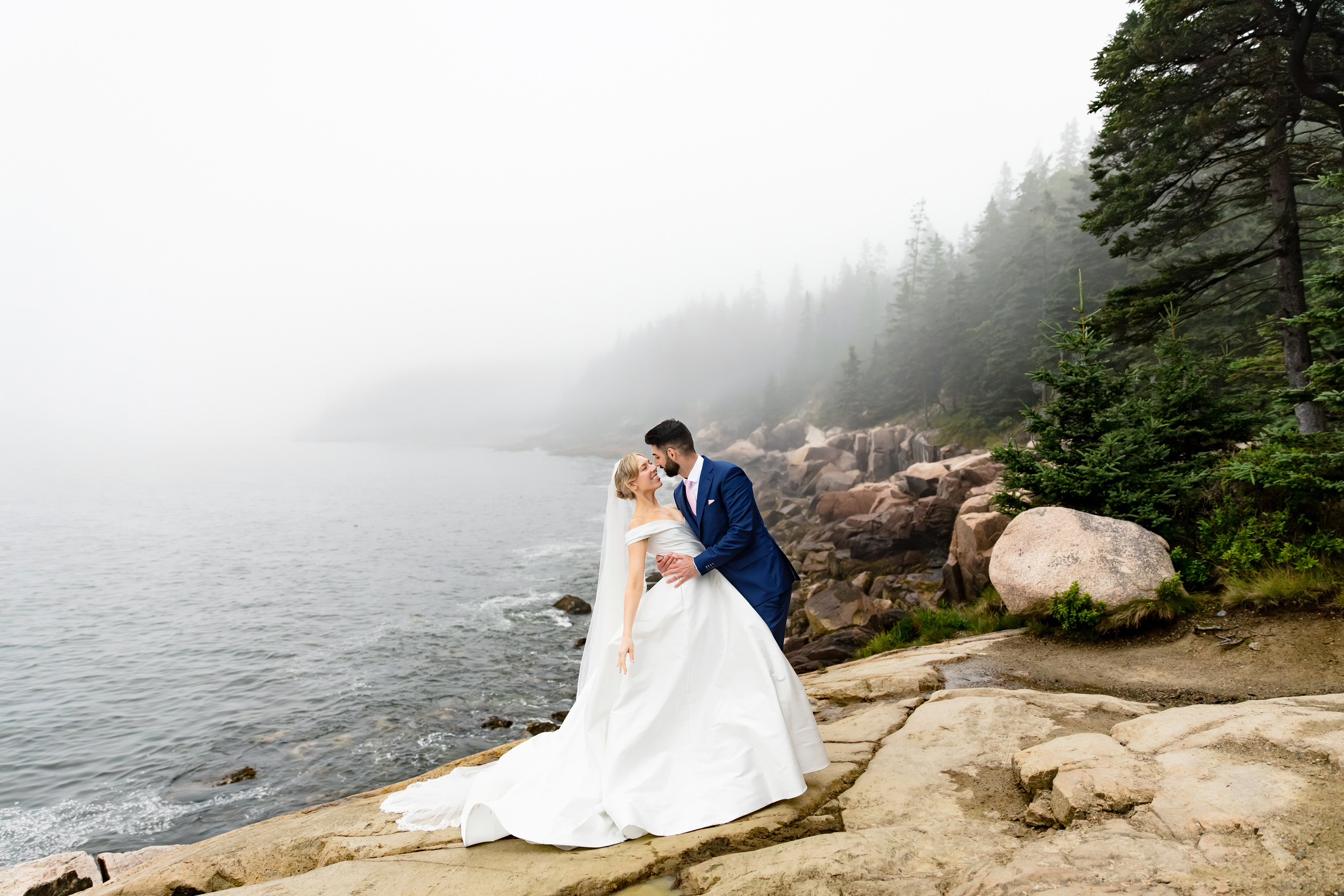 couple on cliffs foggy wedding portraits in Acadia