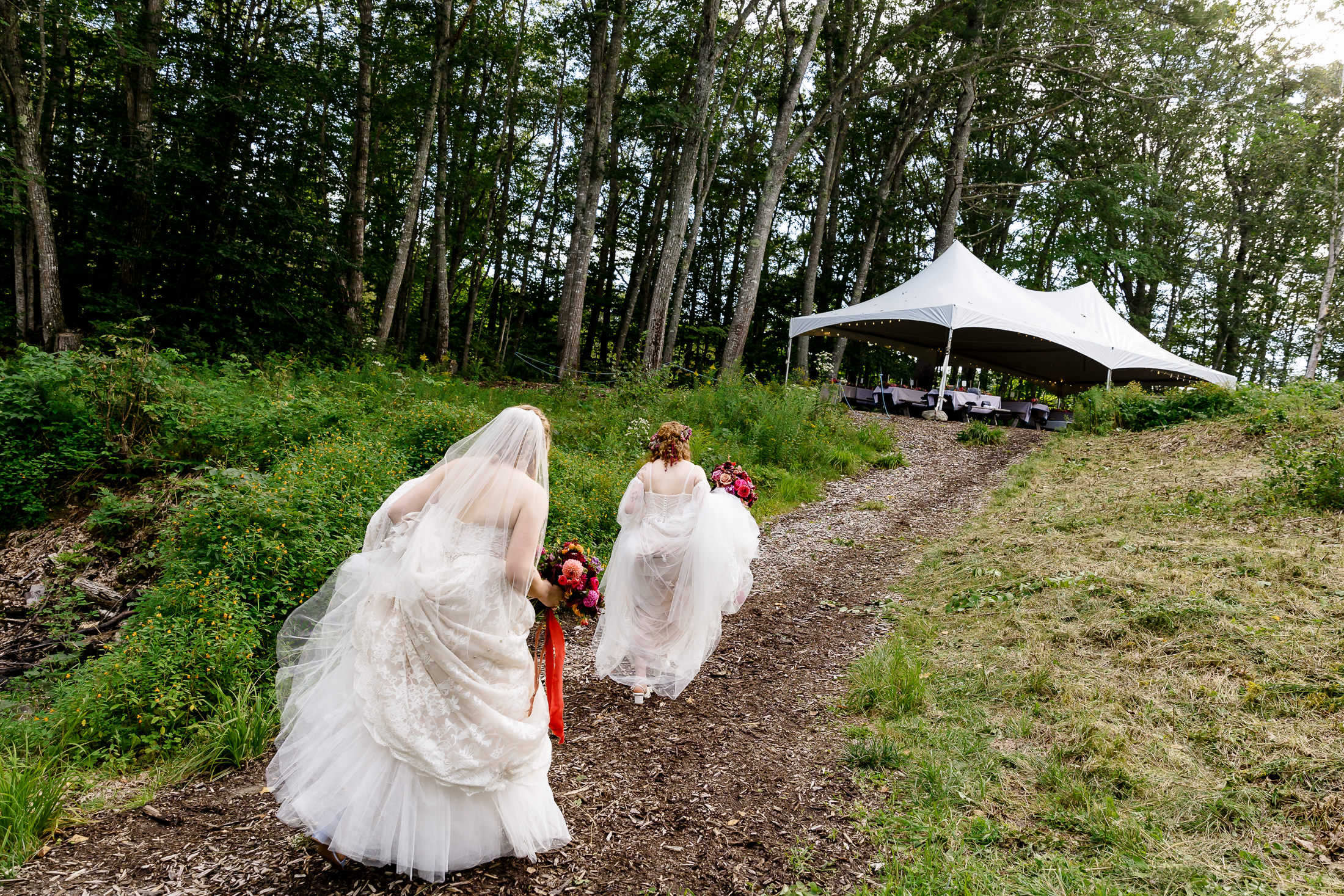 Brides walking to reception during Edgecomb Maine wedding at Glidden Point Oyster Farms
