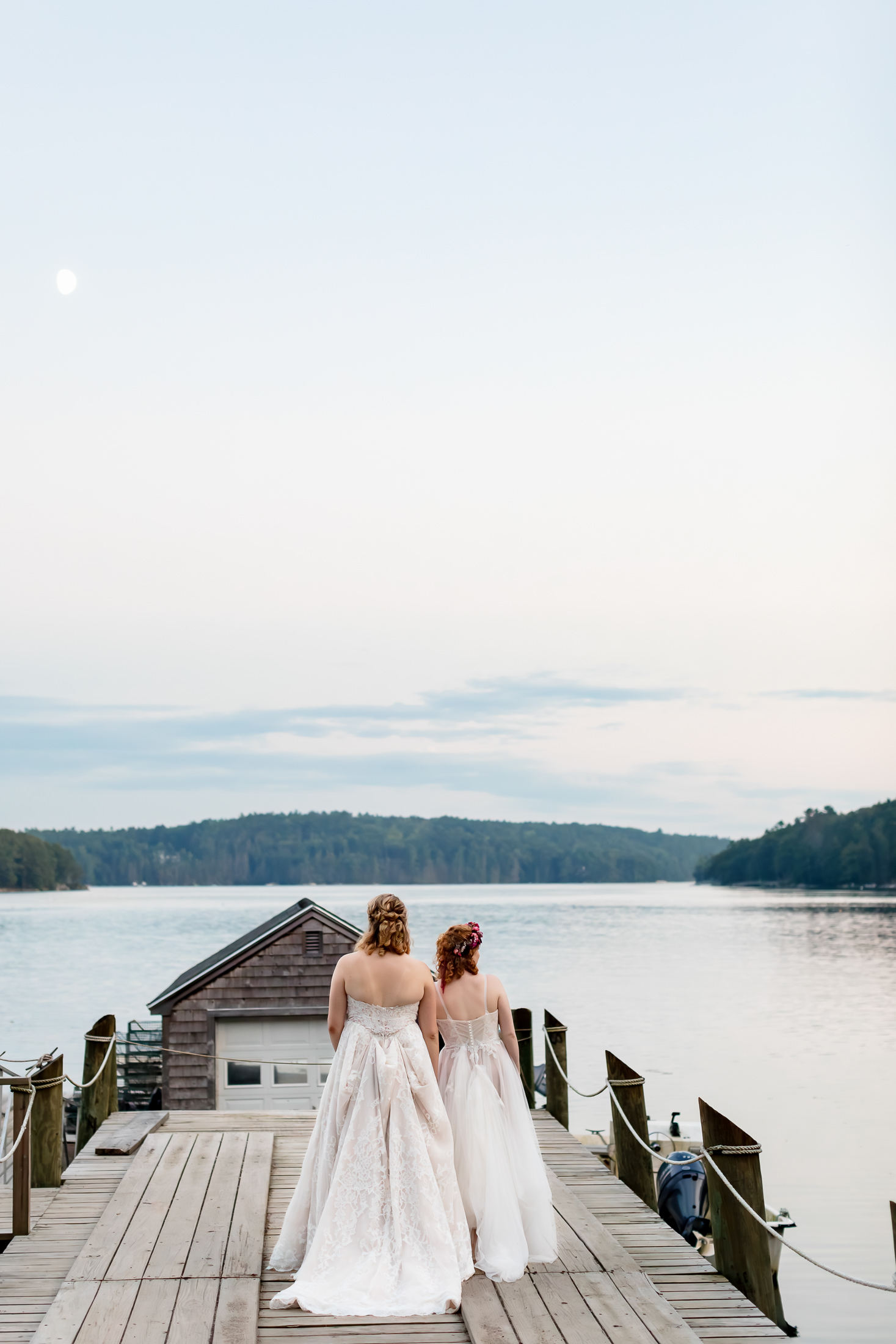 two brides at sunset during Edgecomb Maine wedding at Glidden Point Oyster Farms
