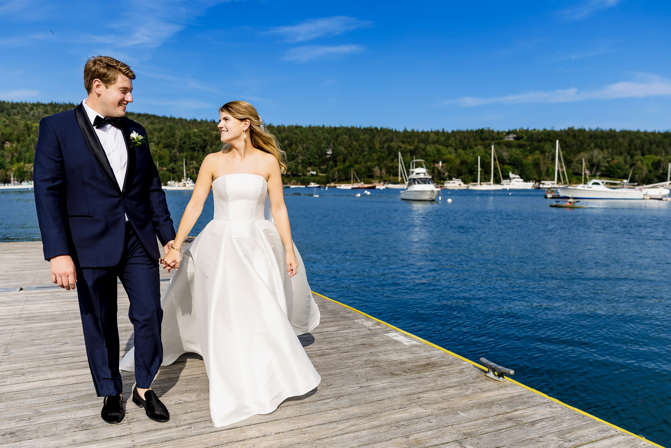 Bride and groom on Northeast Harbor dock during wedding on MDI
