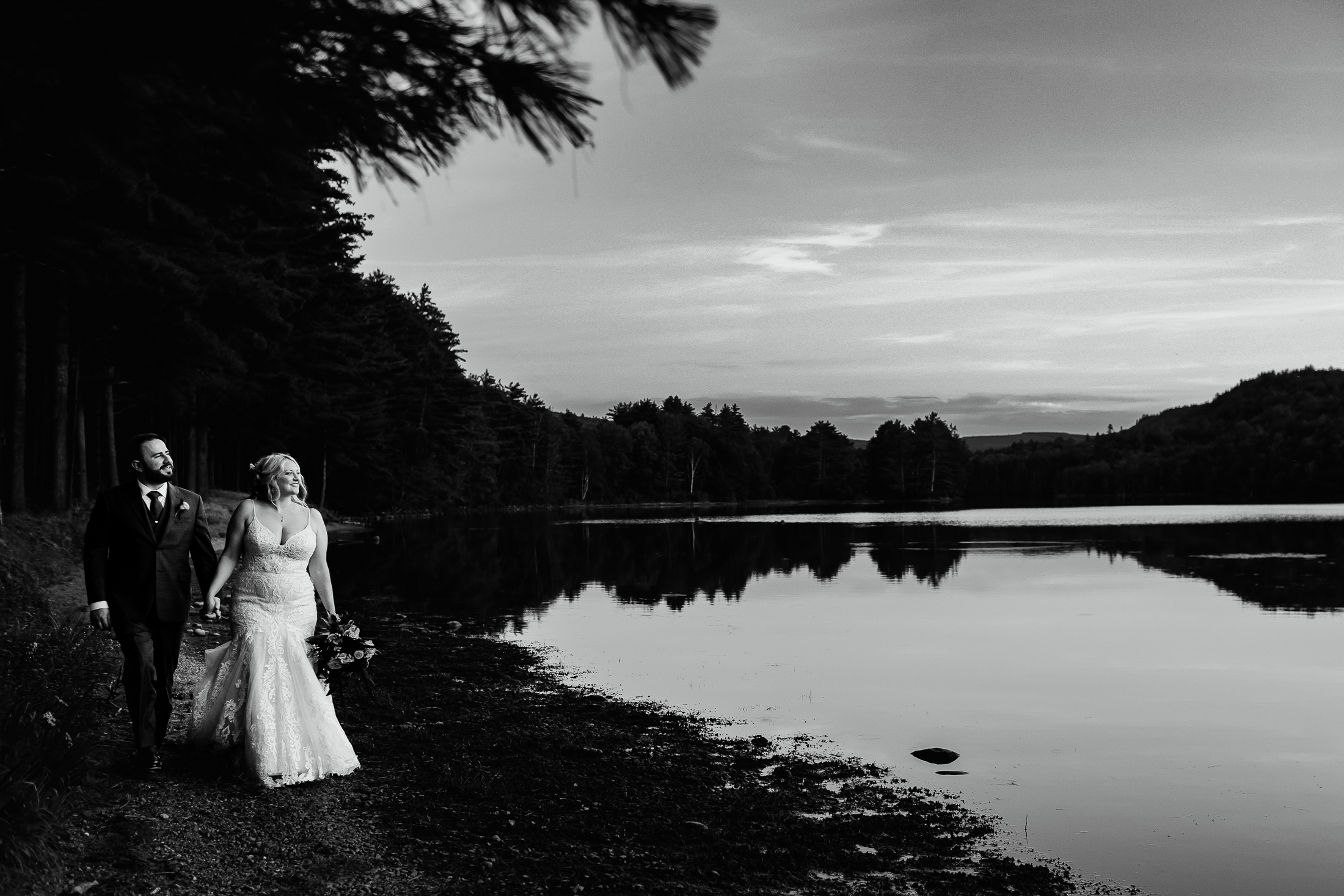 couple walking along the water during Caratunk Maine wedding at Maine Lakeside Cabins