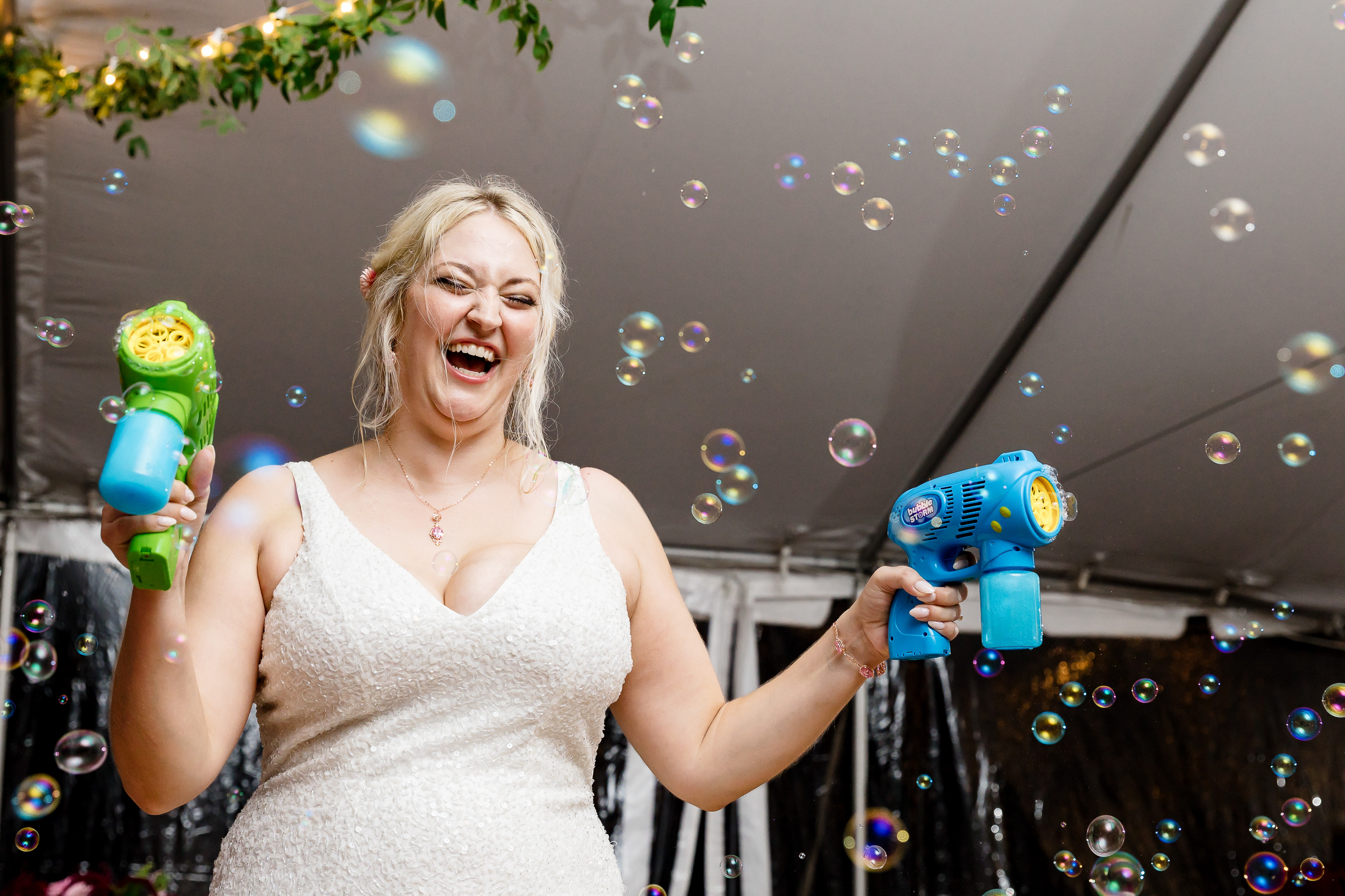 bride with bubble gun at Maine wedding