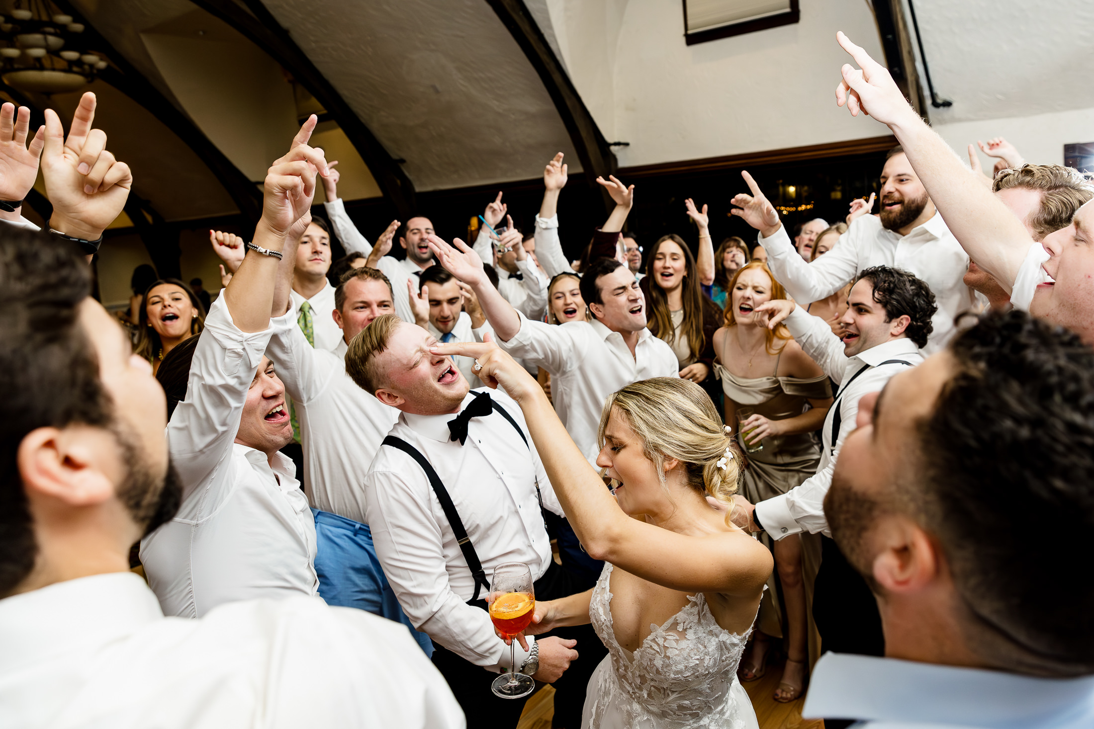 wedding guests surround bride and groom on the dance floor at stormy Bar Harbor wedding