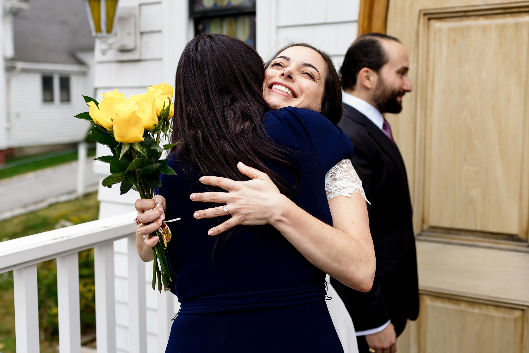 Family hugging couple after their Camden Maine wedding ceremony