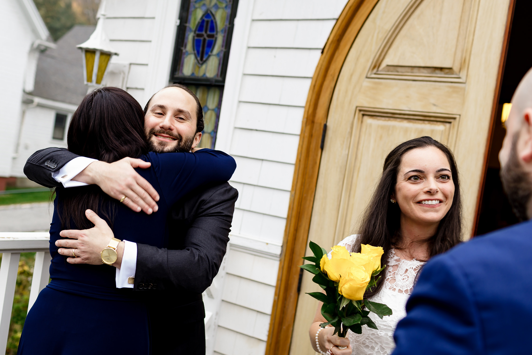 Family hugging couple after their Camden Maine wedding ceremony
