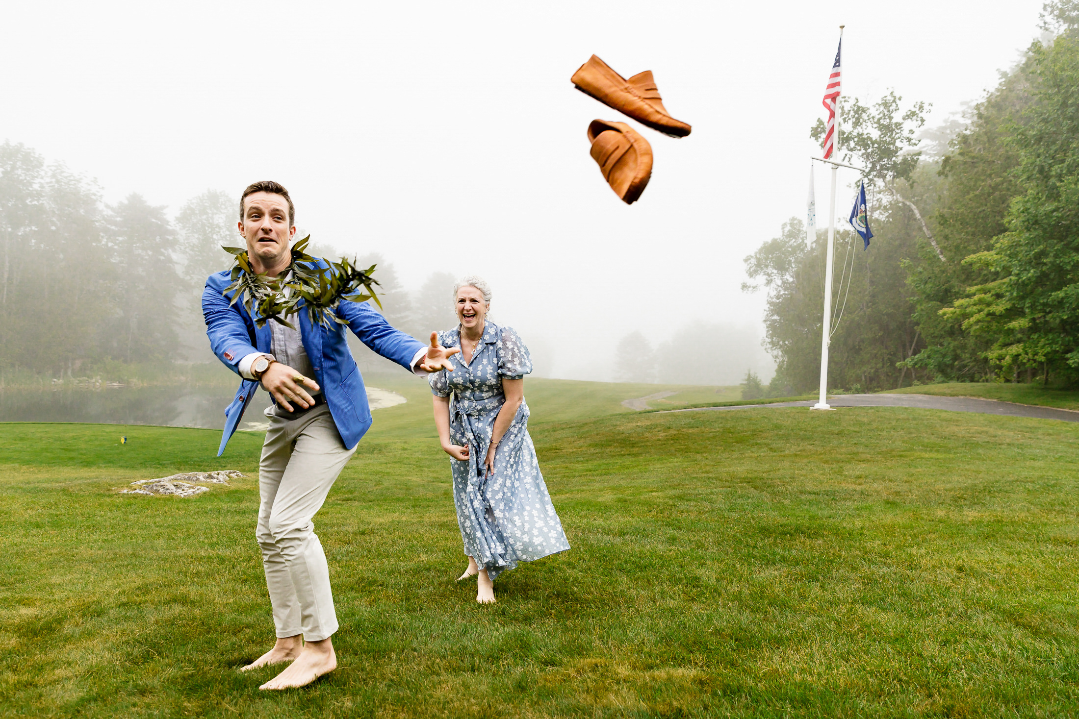 groom tossing his shoes to dance with his mom at Rockport Maine wedding