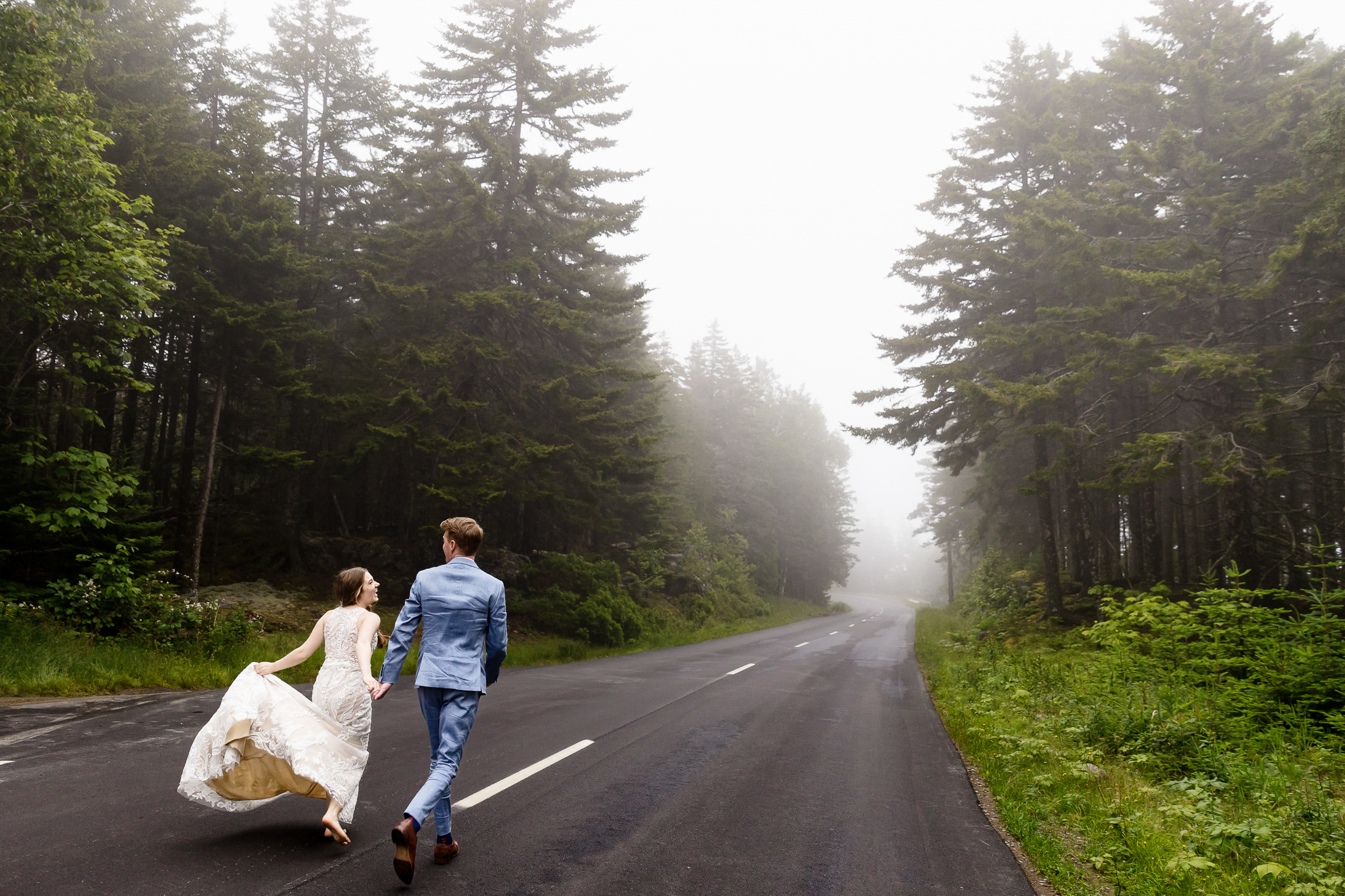 Newlyweds running in Acadia National Park
