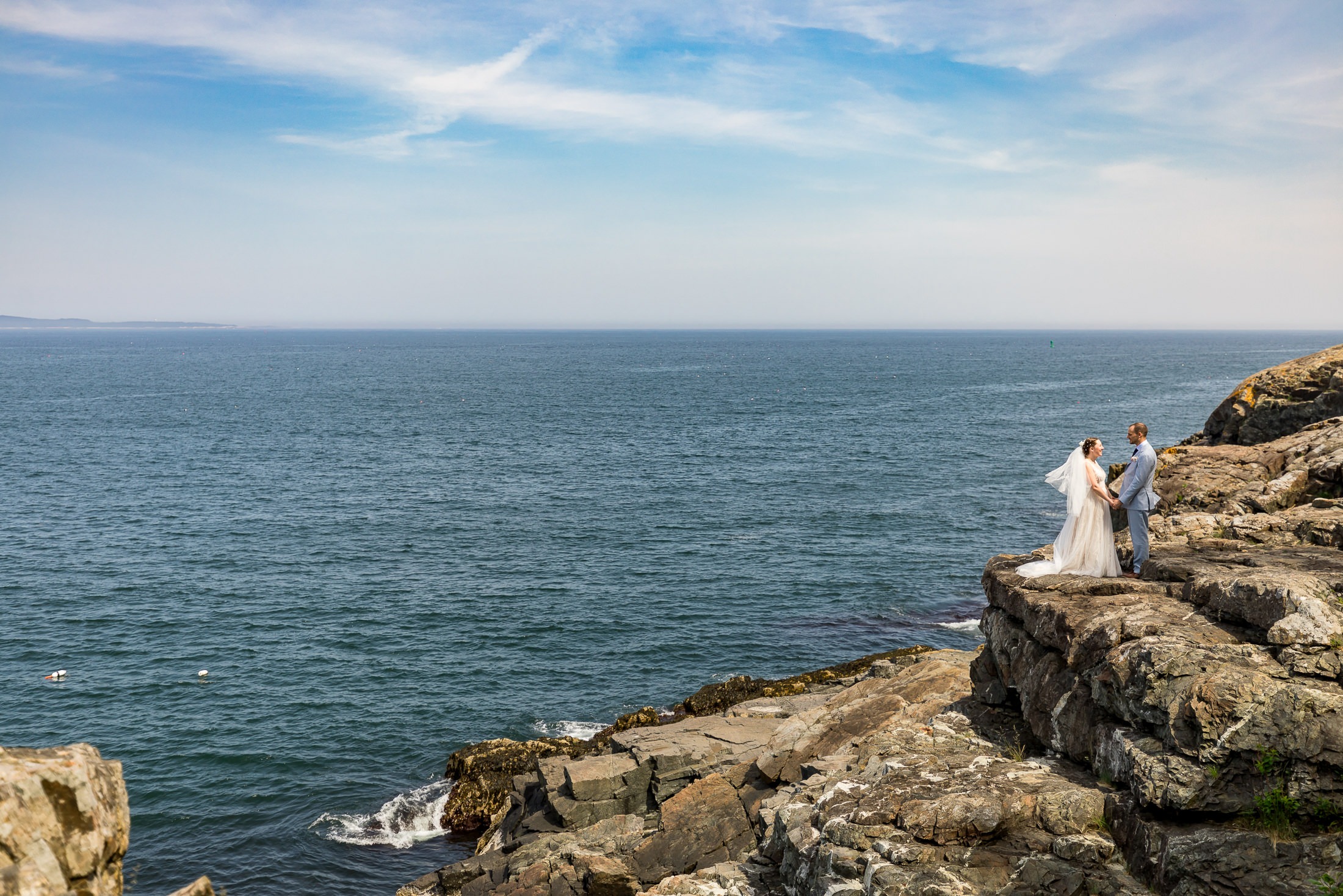 couple on cliffs before Sand Beach Acadia wedding